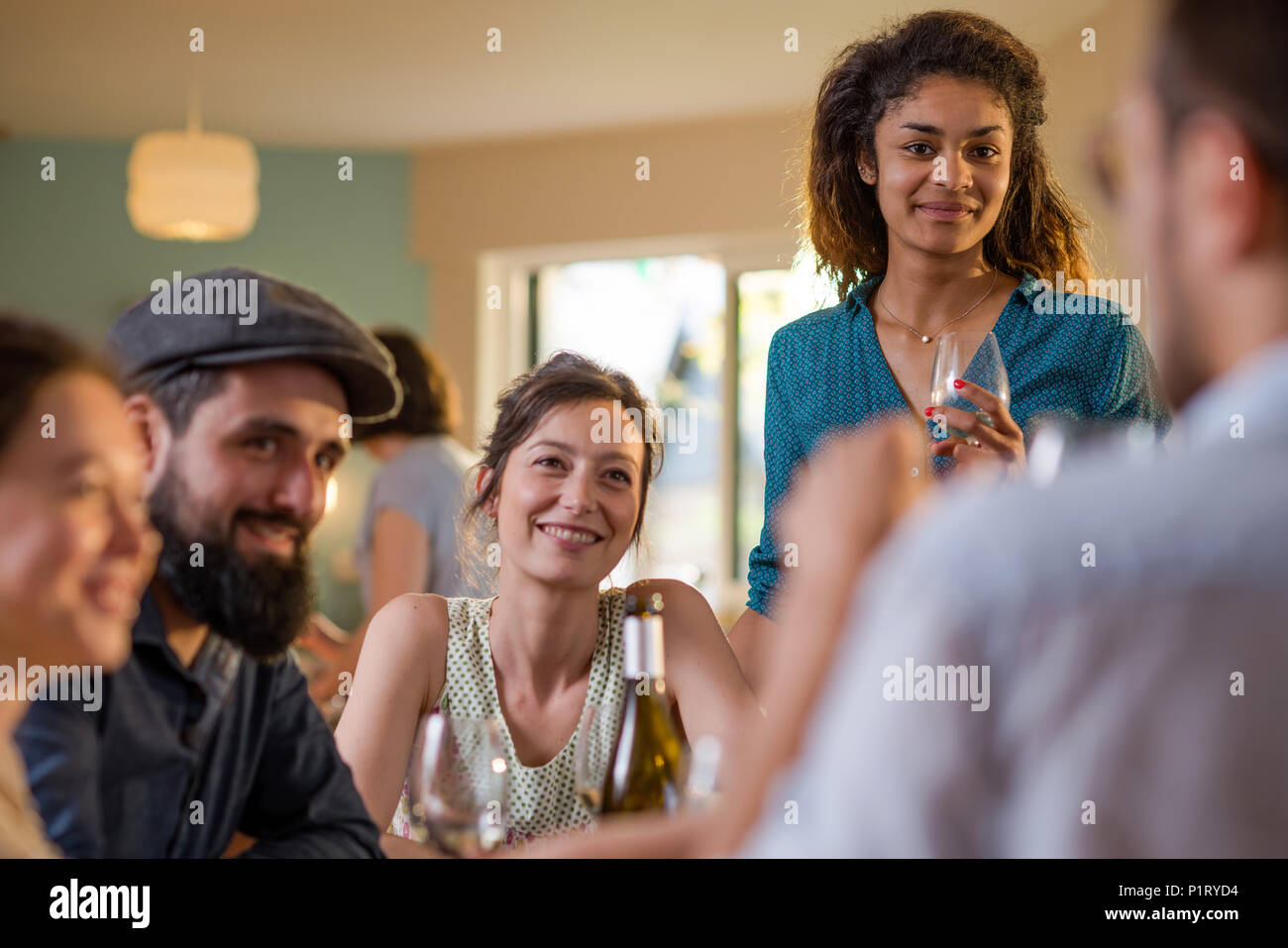 Mixed group of friends having fun while sharing a meal  Stock Photo