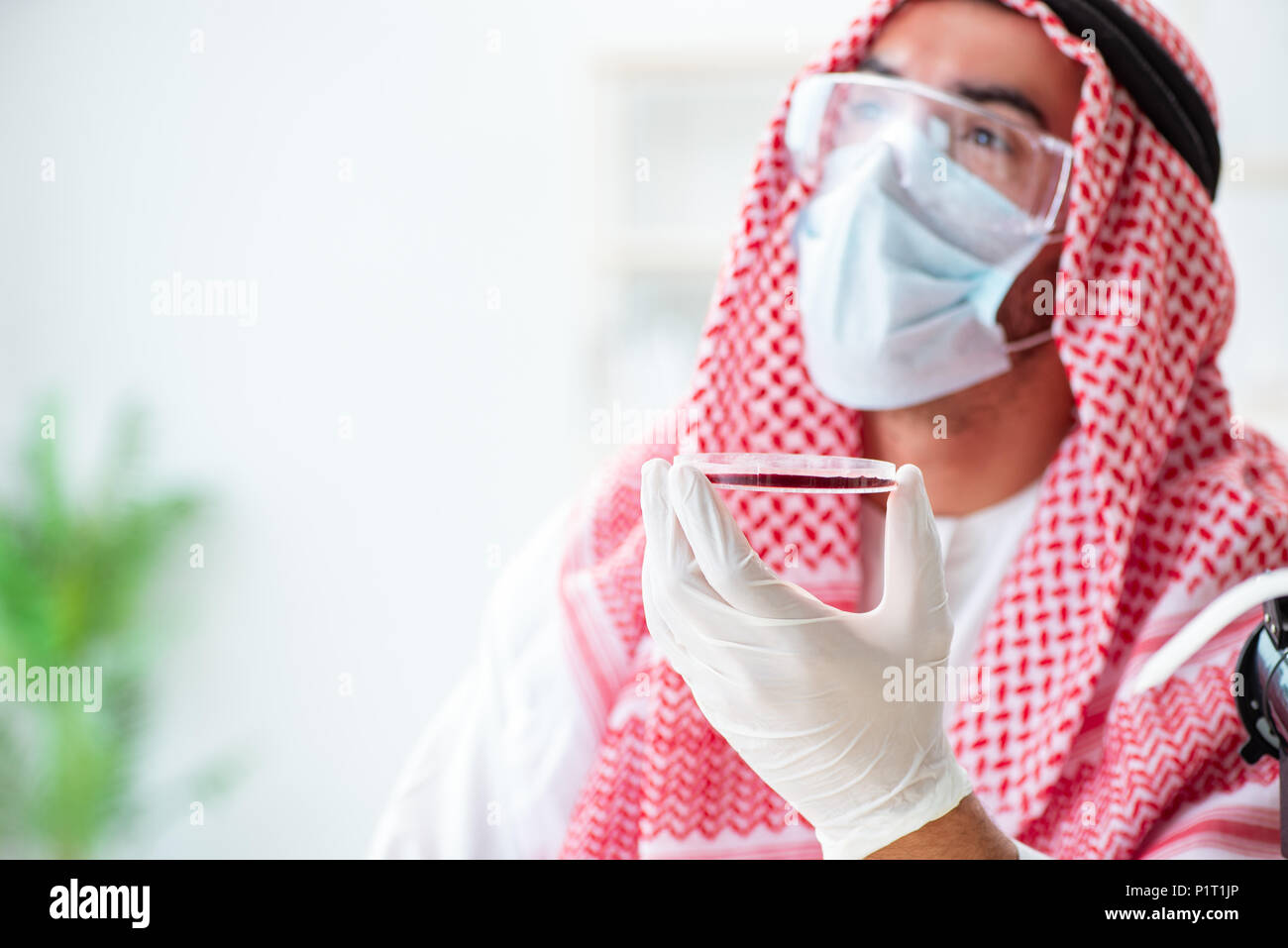 Arab doctor chemist studying new virus in lab Stock Photo