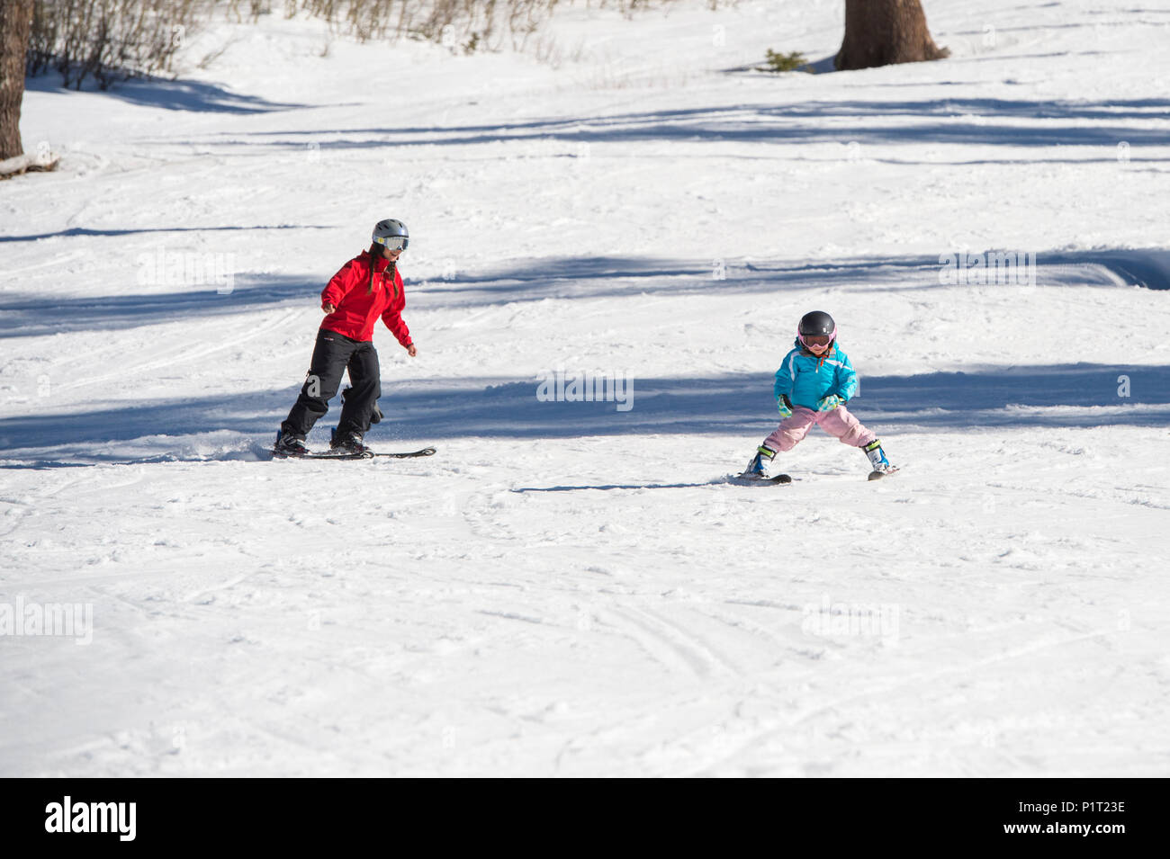 Mother teaching young daughter how to ski at Squaw Valley Ski Resort in California, North America. Stock Photo