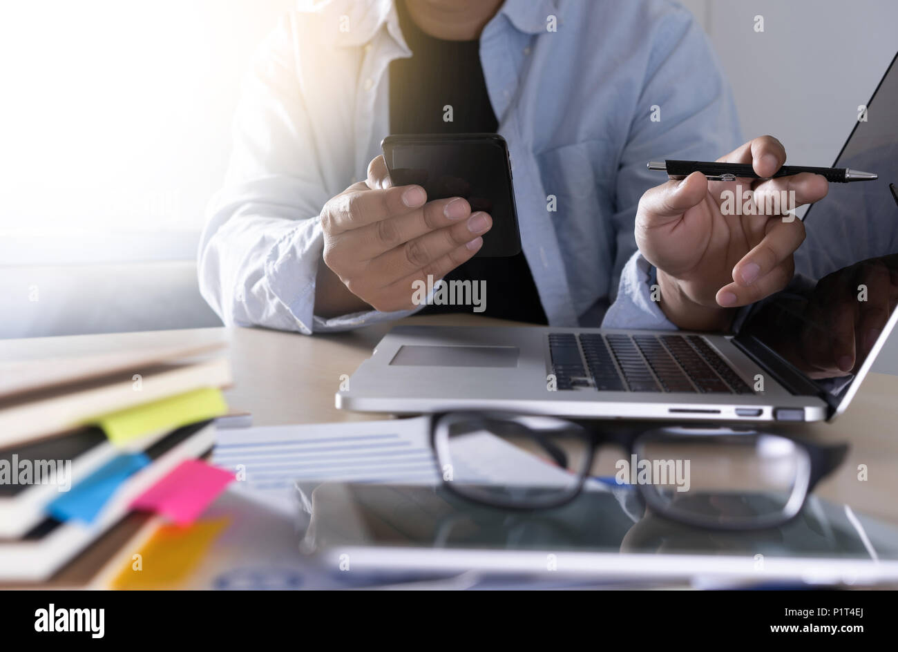 businessman using phone smart phone and notebook computer Stock Photo