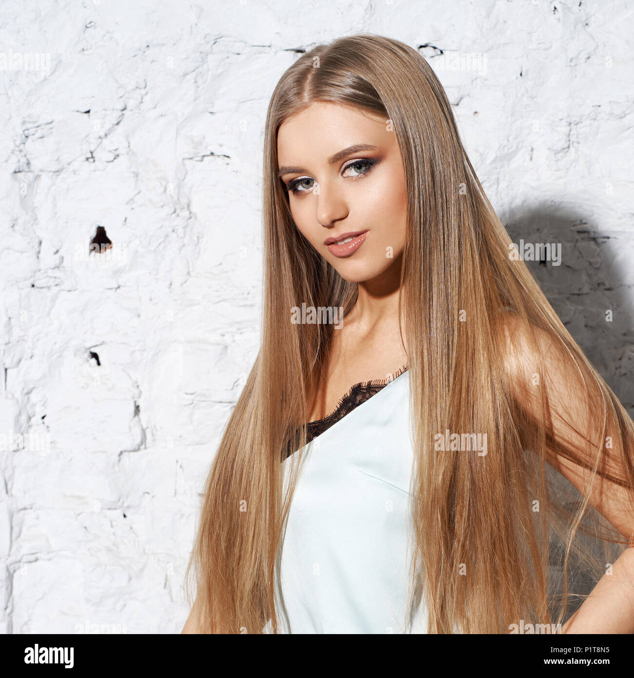 Cute girl with long straight blonde hair and healthy skin