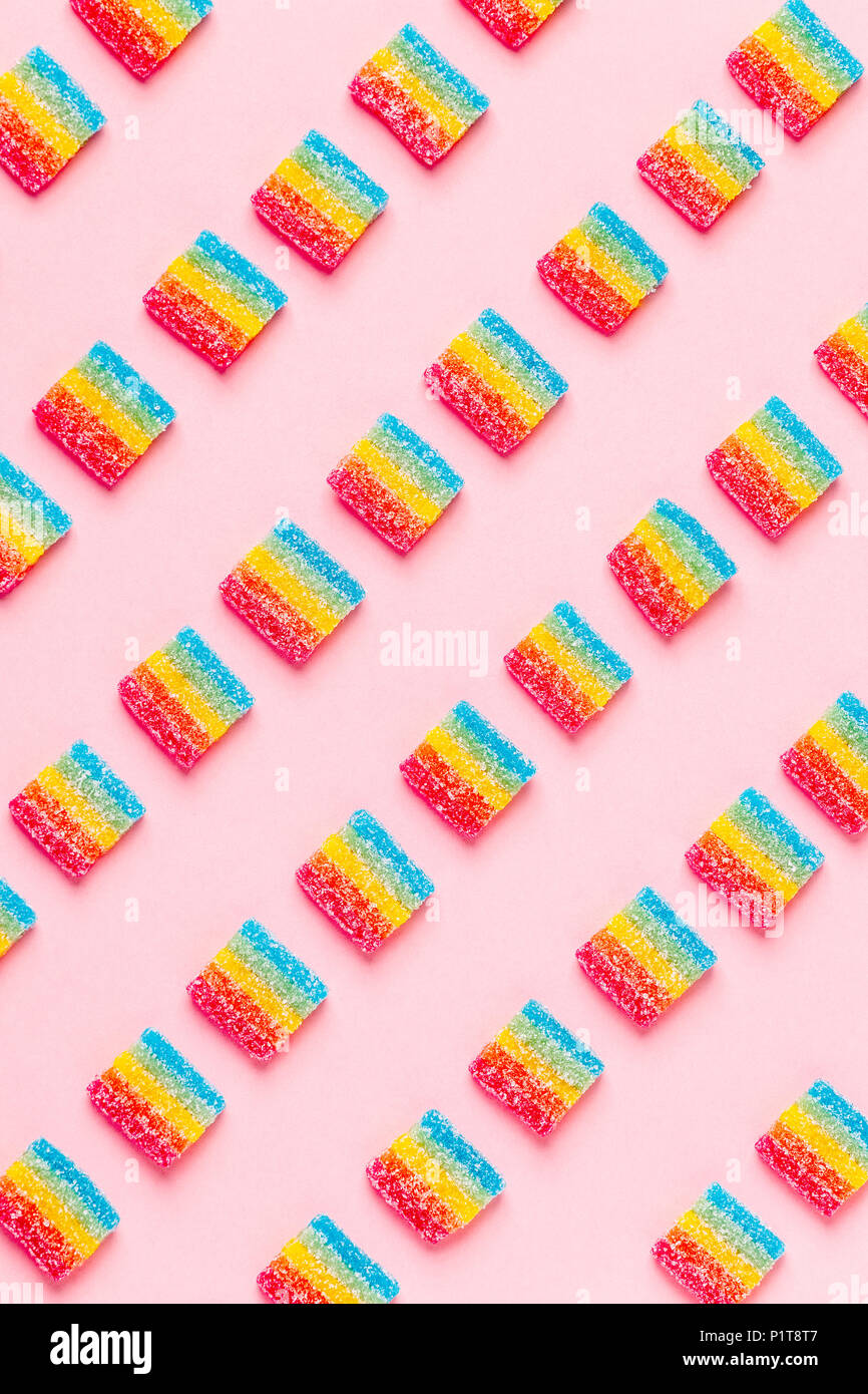 Colorful candies pattern on a pink background. Top view. Stock Photo