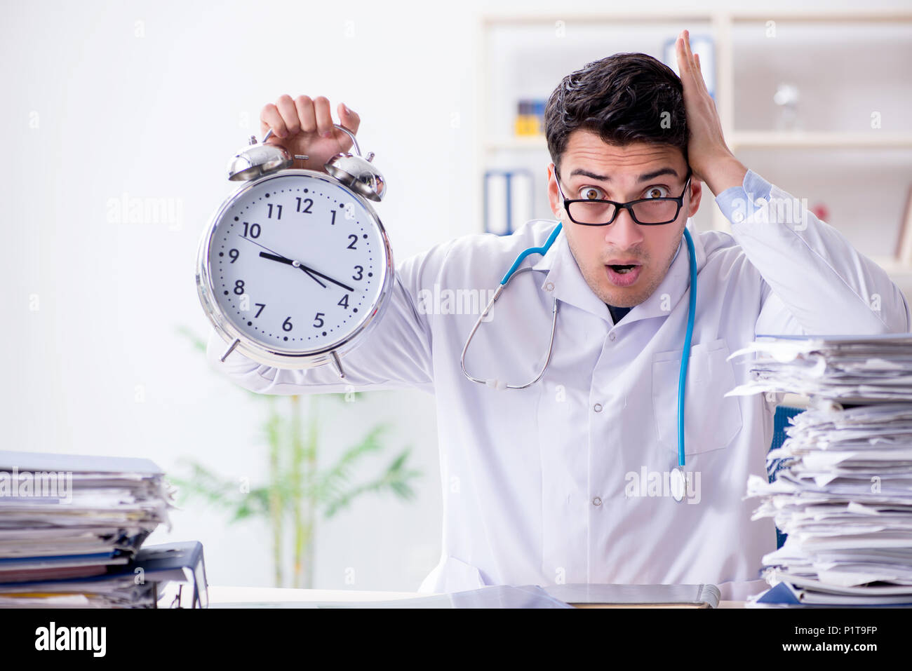 Doctor with alarm clock in urgent checkup concept Stock Photo Alamy