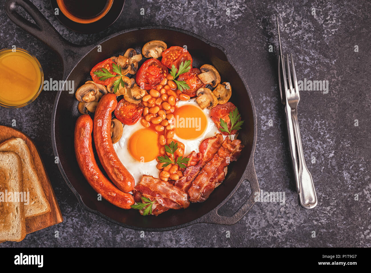 Traditional full English breakfast with fried eggs, sausages, beans