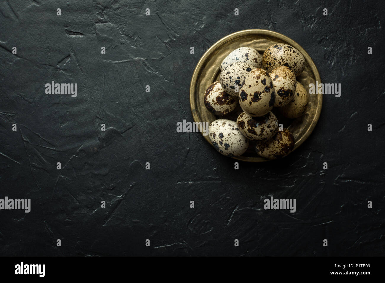 Quail Eggs on Dark Stone Background Stock Photo
