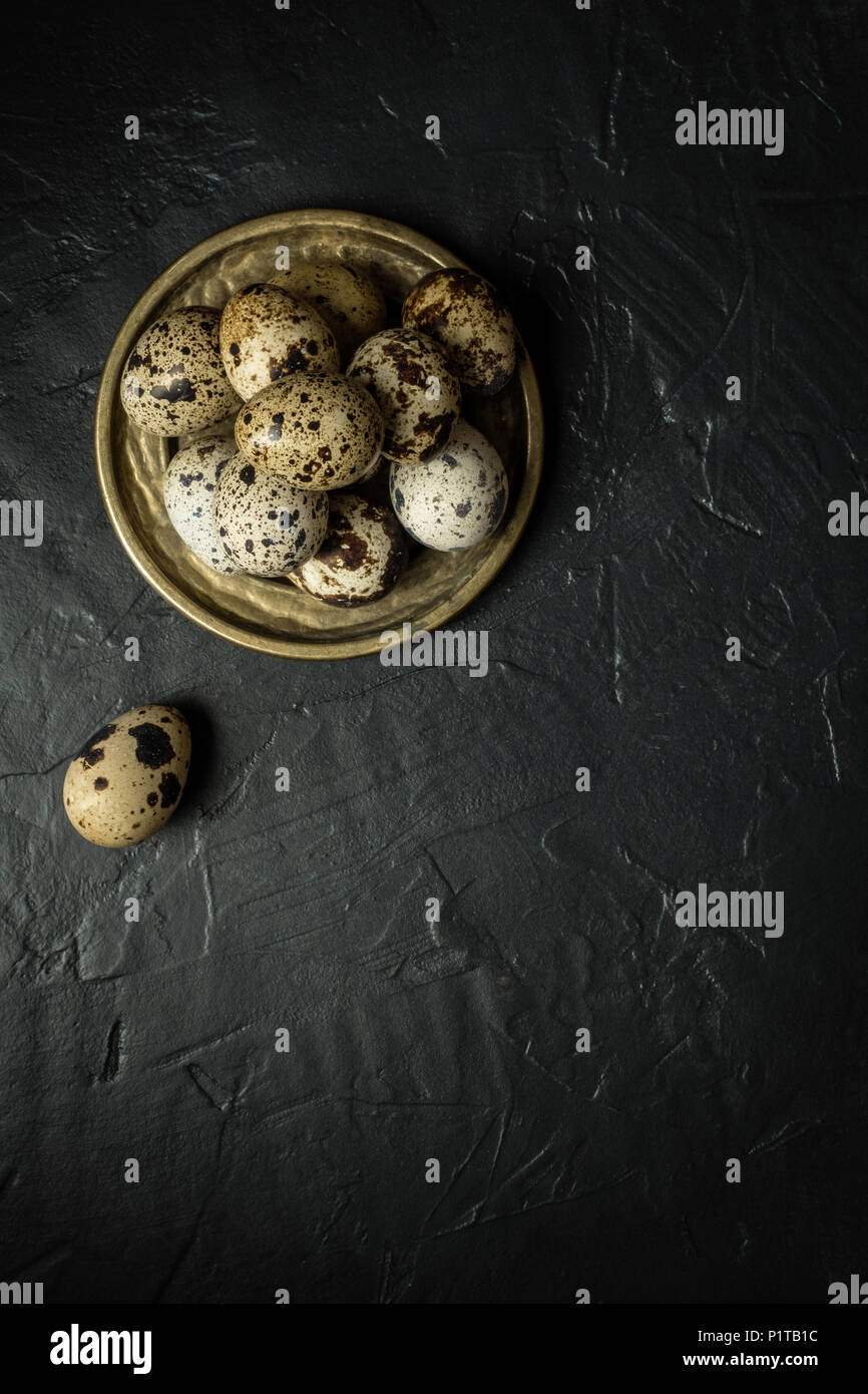 Quail Eggs on Dark Stone Background Stock Photo