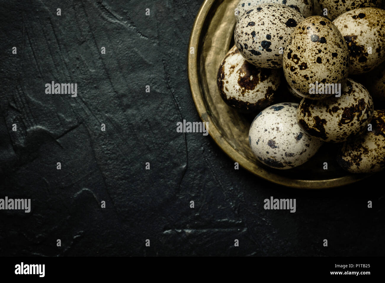 Quail Eggs on Dark Stone Background Stock Photo