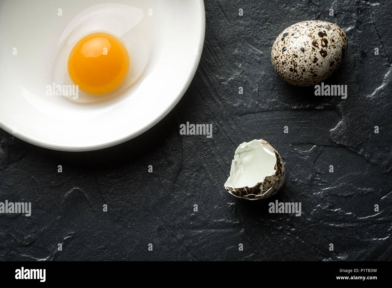 Raw Broken Quail Egg Yolk in White Bowl Stock Photo