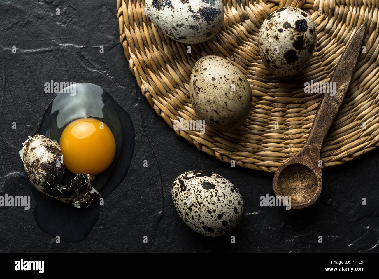 Broken Raw Egg Yolk on Dark Stone Background Stock Photo
