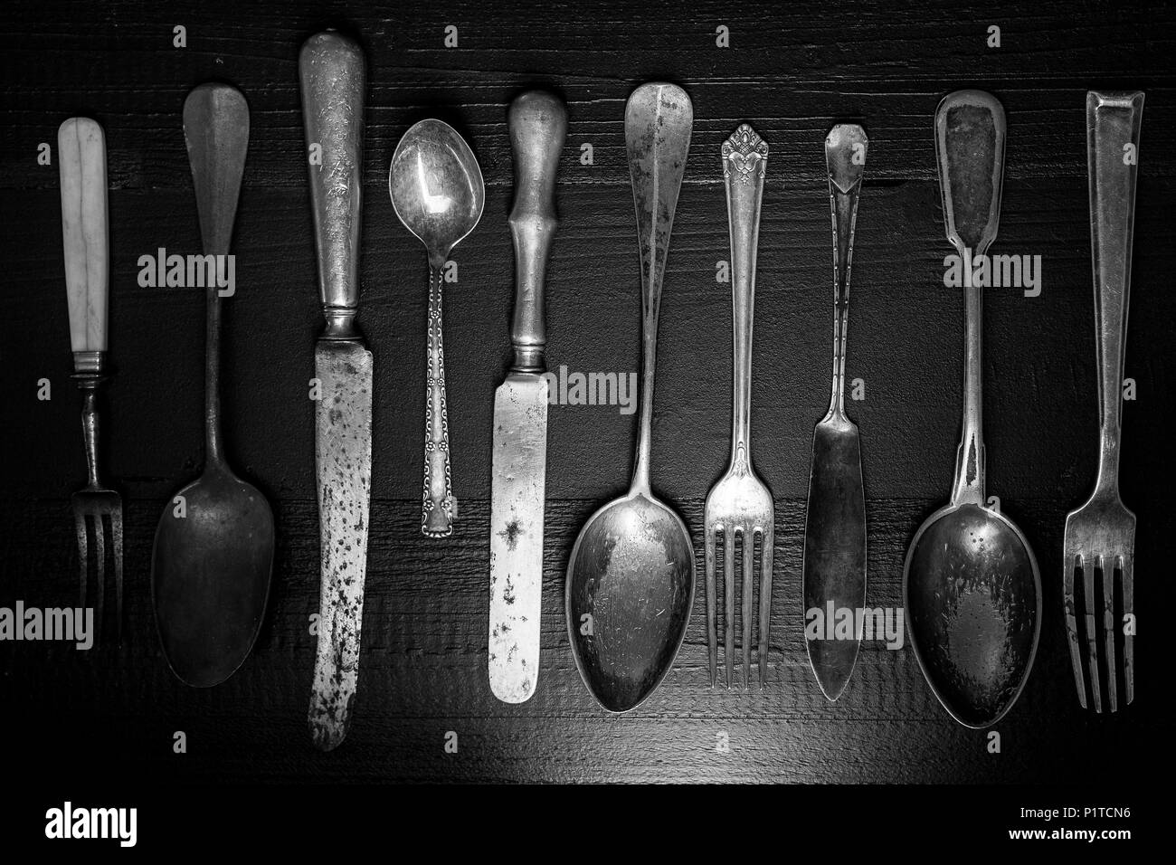 Rustic Cutlery on Old Dark Wooden Background. Silverware and Food Concept. Stock Photo