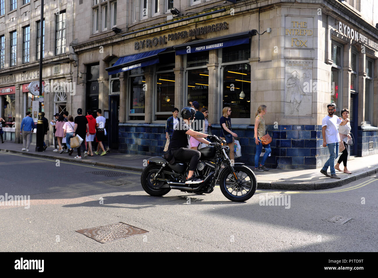 Man riding Harley Davidson motorcycle, Soho, London, England, UK Stock Photo
