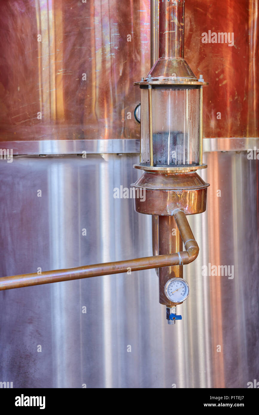 Alcohol copper still alembic with control gauge closeup inside distillery Stock Photo