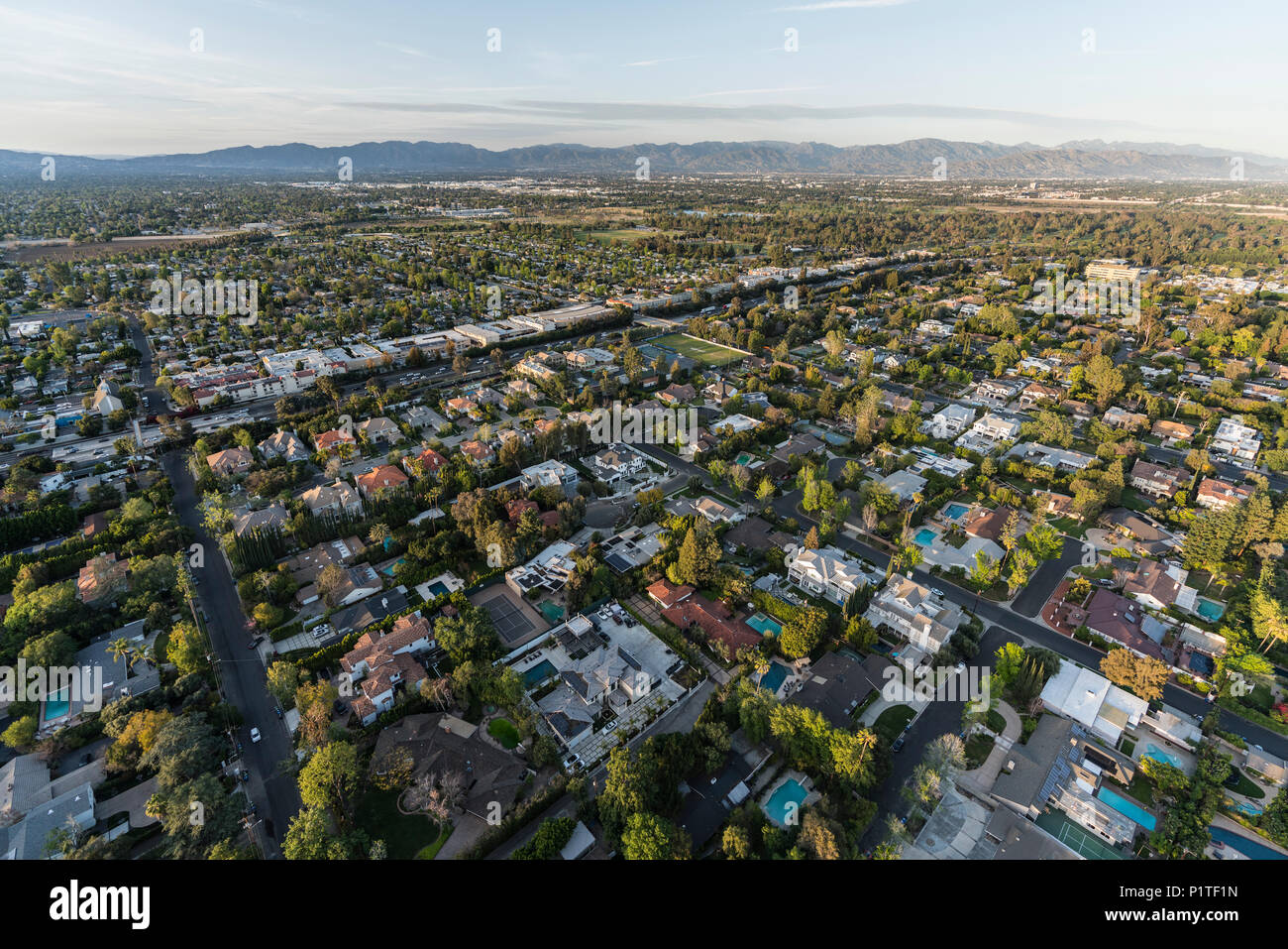 Afternoon aerial view of Encino homes and streets in the San Fernando Valley area of Los Angeles, California. Stock Photo