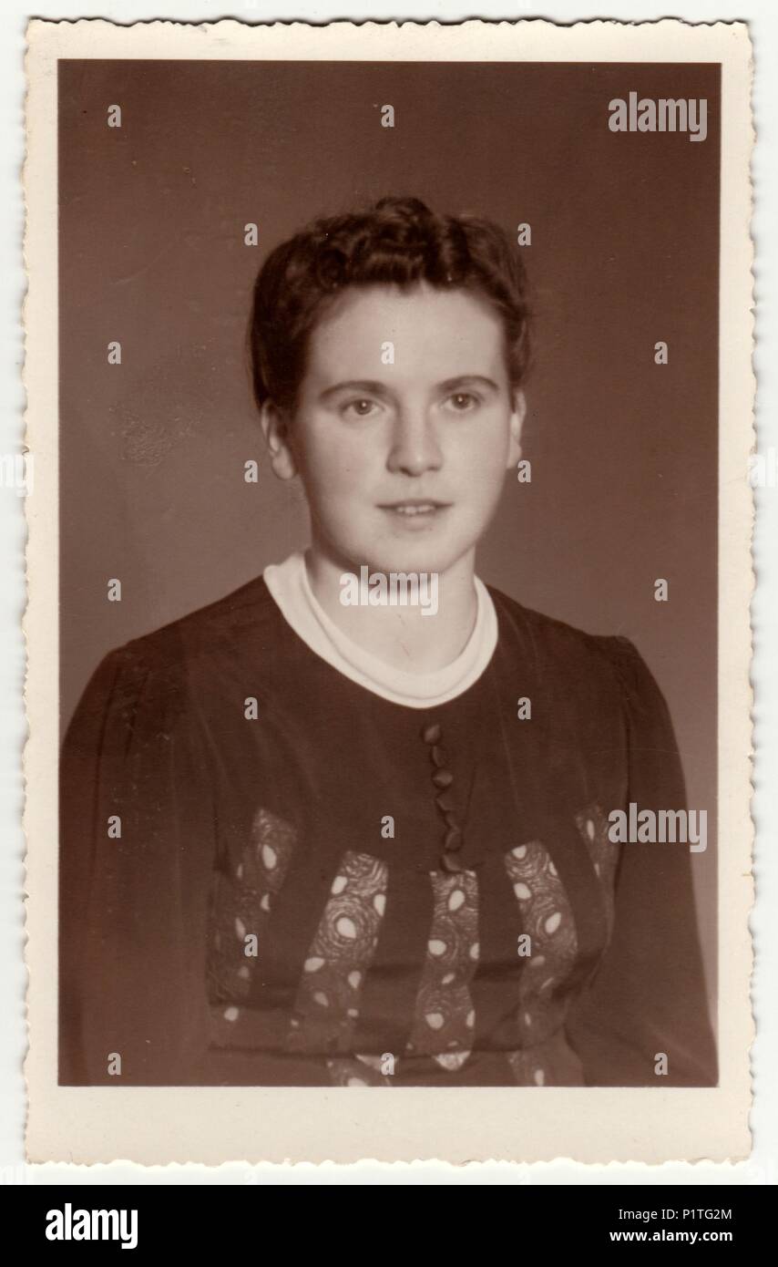 GERMANY - CIRCA 1950s: Vintage photo shows woman with short hair. Retro black & white studio photography with sepia effect. Stock Photo