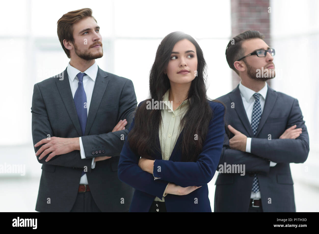 Smiling business team standing with arms crossed Stock Photo - Alamy