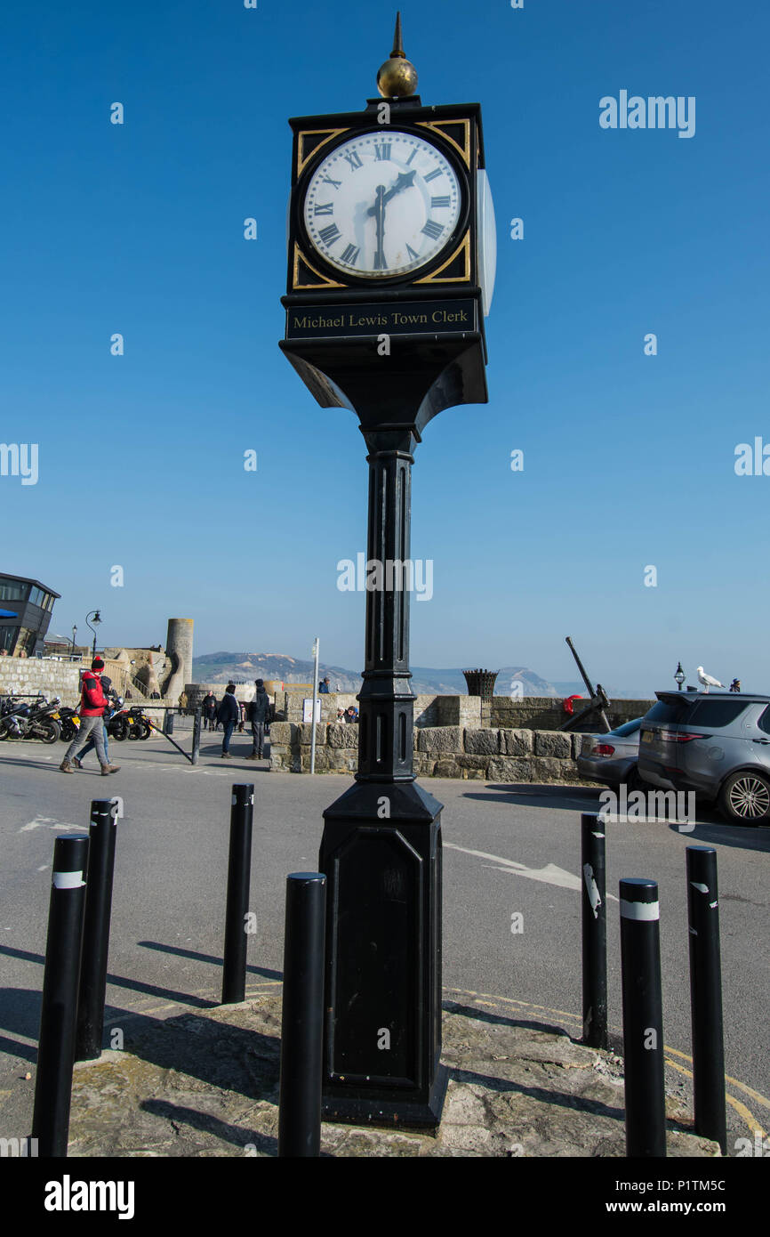 Street clock on the beach Lime Regis famous chime chimes black gold