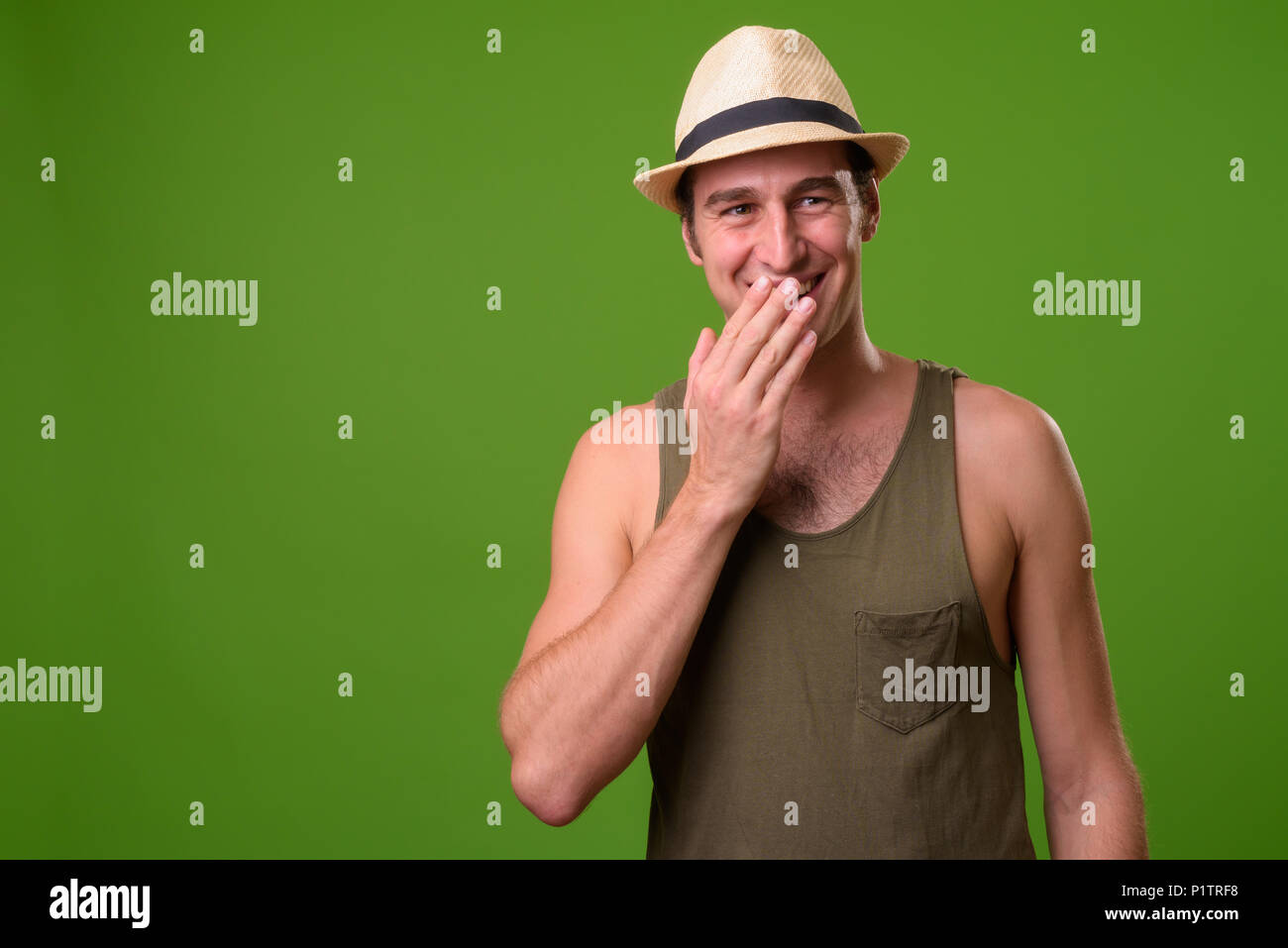 Young tourist man against green background Stock Photo