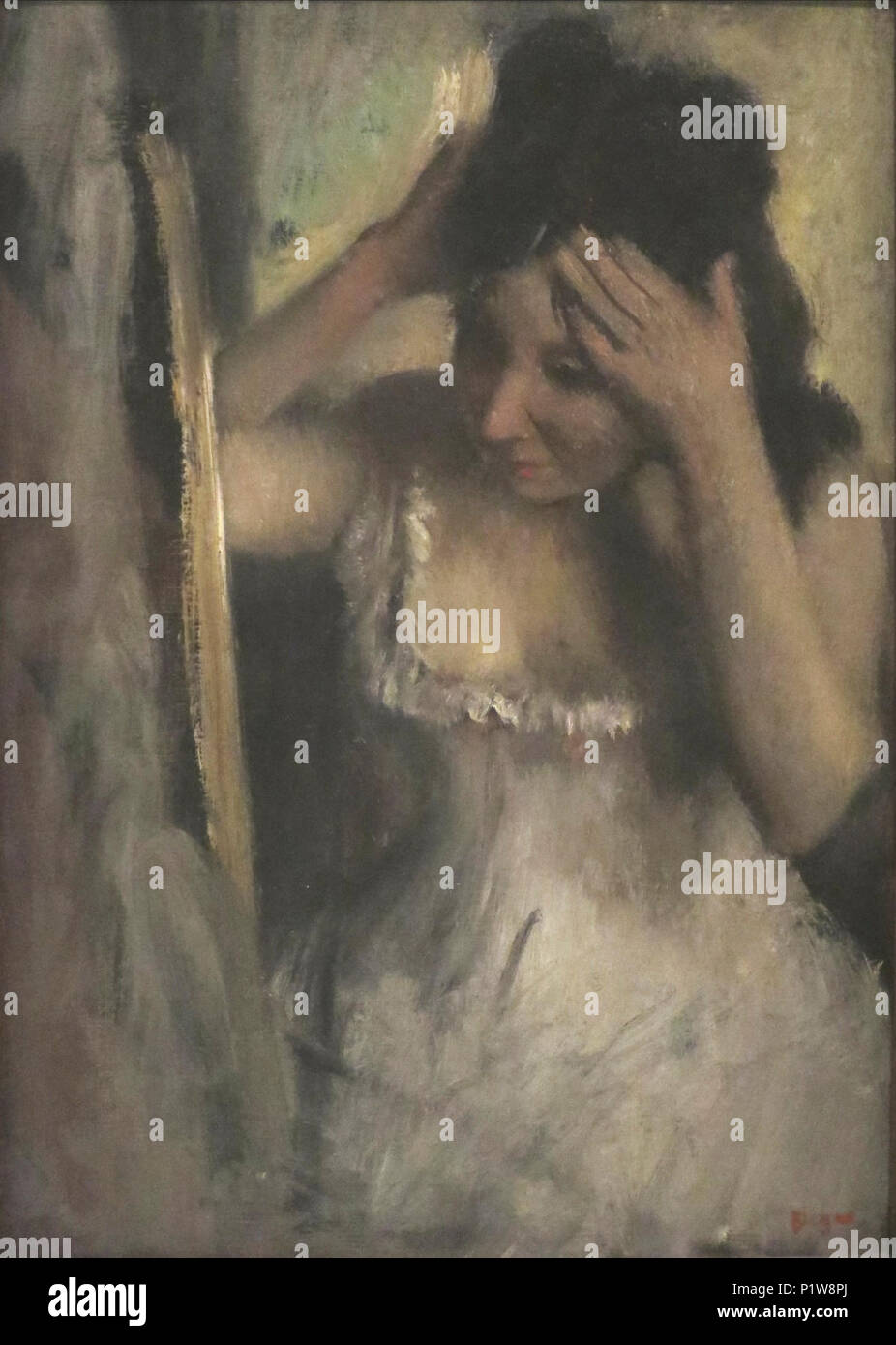 'Woman Combing her Hair before a Mirror' by Edgar Degas Stock Photo