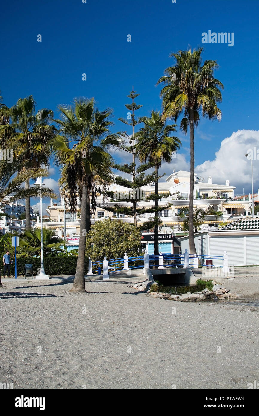 NERJA, ANDALUCIA, SPAIN - DECEMBER 19, 2017: Burriana sandy beach and stores on a sunny day on December 19, 2017 in Nerja, Andalucia, Spain Stock Photo