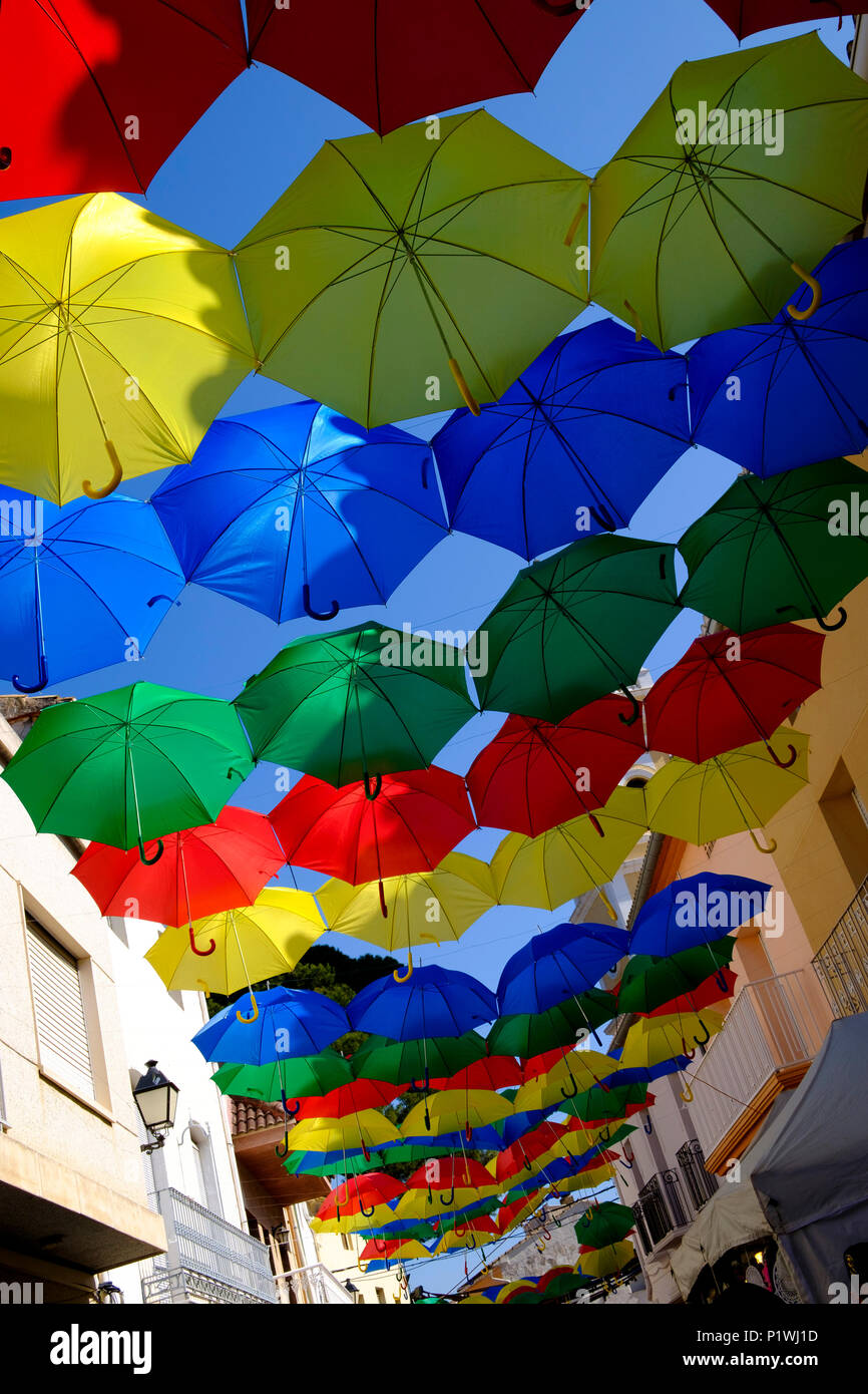 Colourful Umbrellas over streets in Spanish Village during Fiesta Stock Photo
