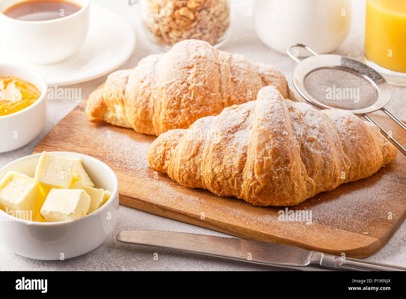 Continental breakfast with fresh croissants, orange juice and coffee, selective focuse. Stock Photo