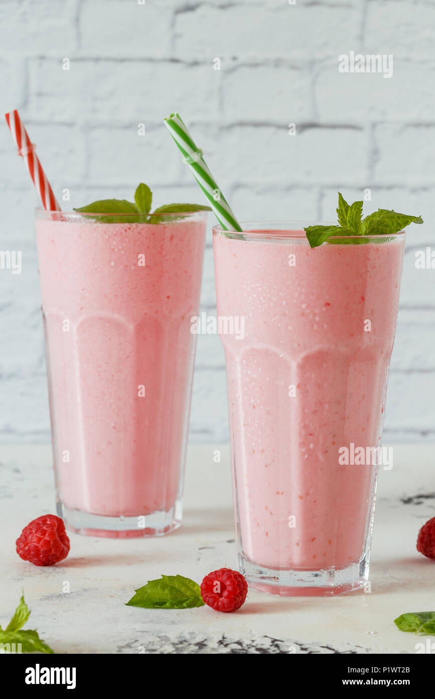 Raspberry milkshake with mint and drinking straws. Stock Photo