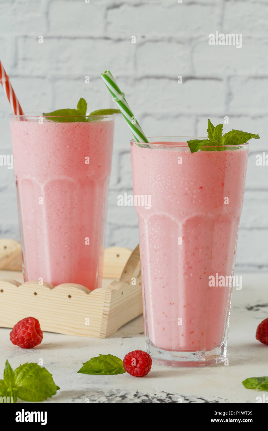 Raspberry milkshake with mint and drinking straws. Stock Photo