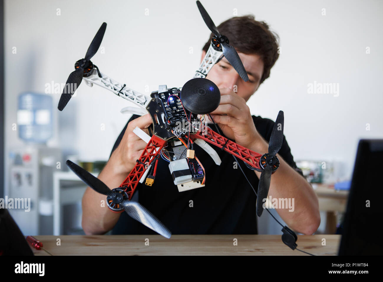 Image of engineer mending square cop sitting at table Stock Photo