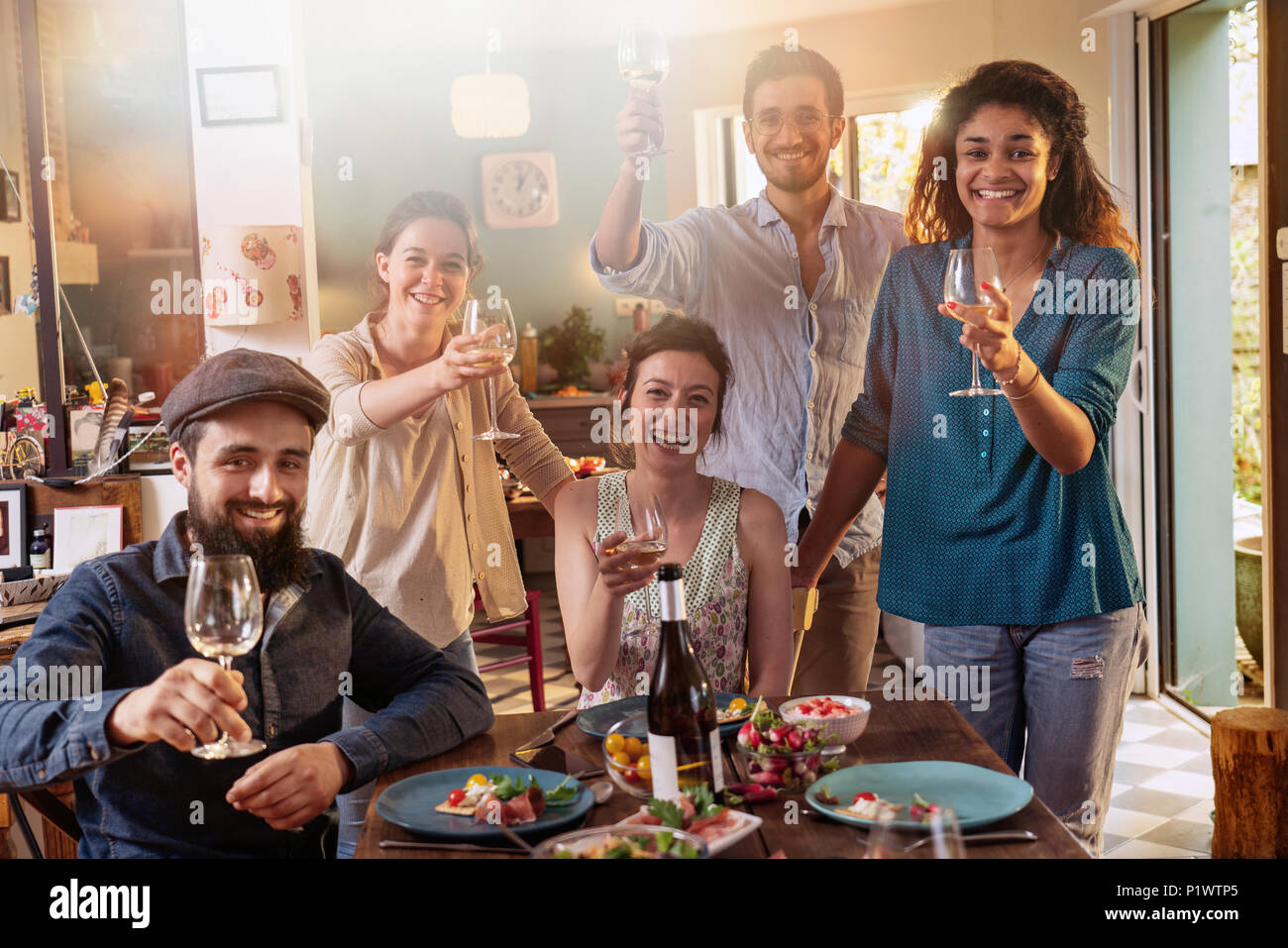 Mixed group of friends having fun while sharing a meal  Stock Photo