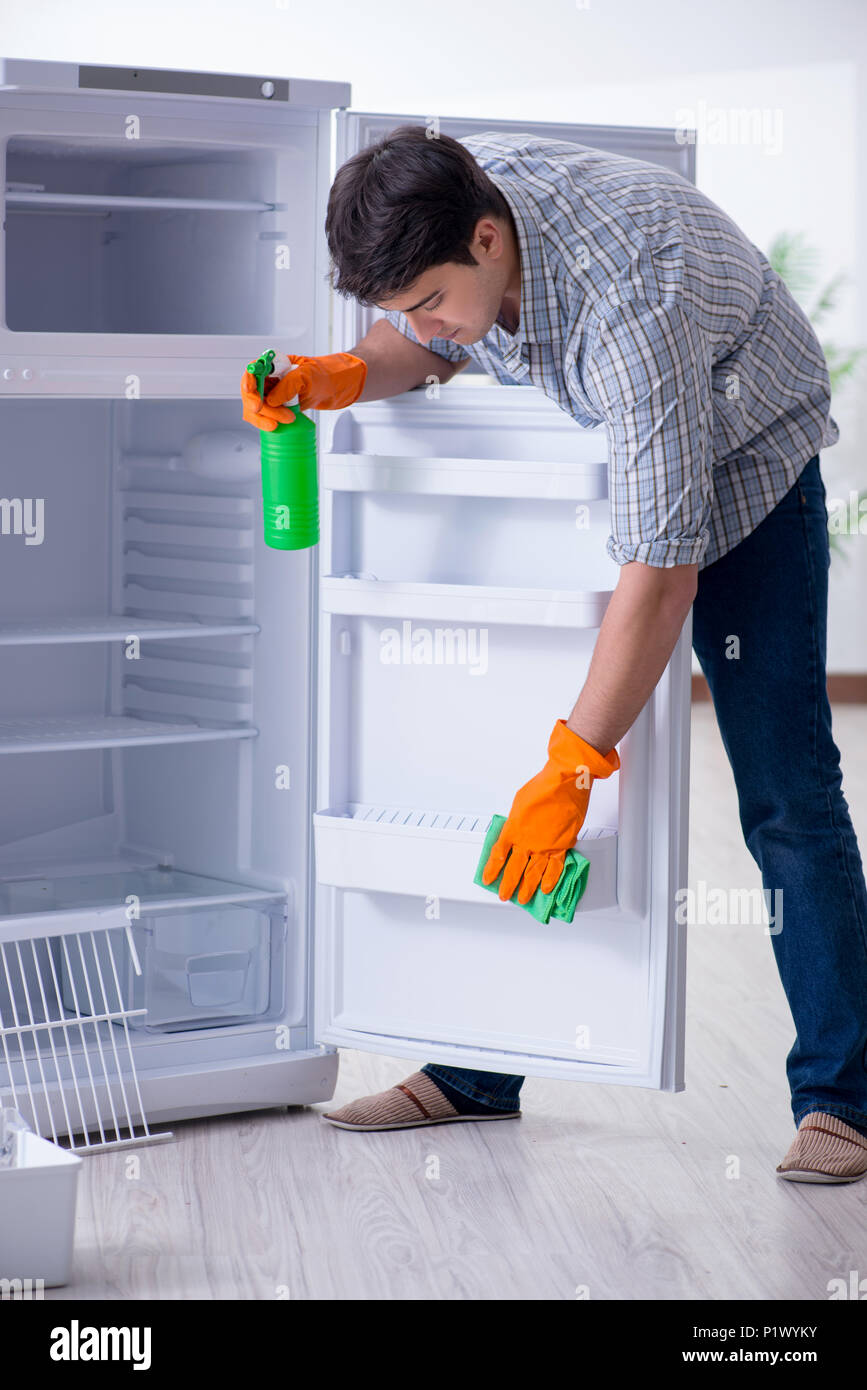 Man cleaning fridge in hygiene concept Stock Photo Alamy