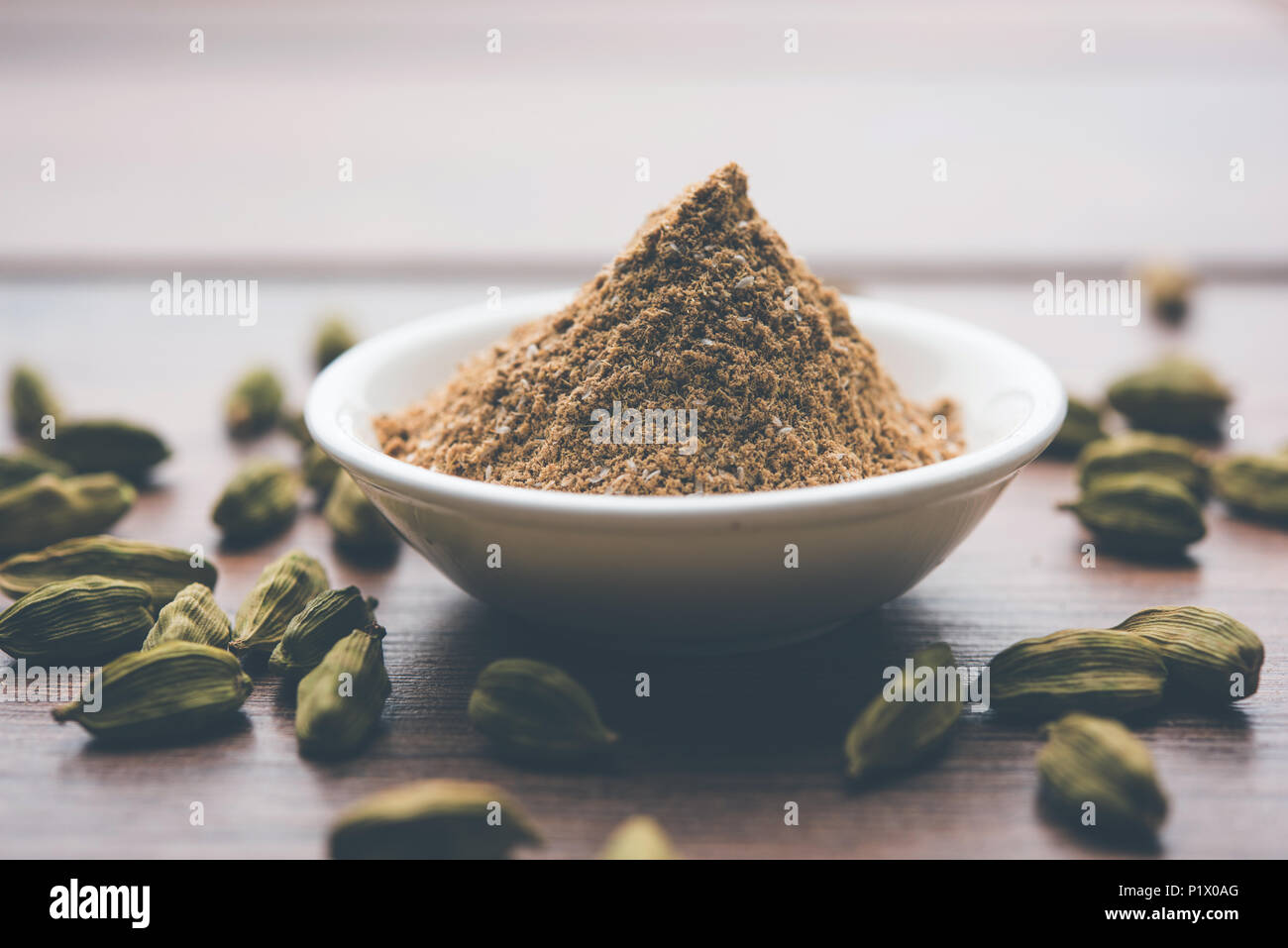 elaichi high resolution stock photography and images alamy https www alamy com elaichi or cardamom powder in bowl or heap over moody background with pods selective focus image207710120 html