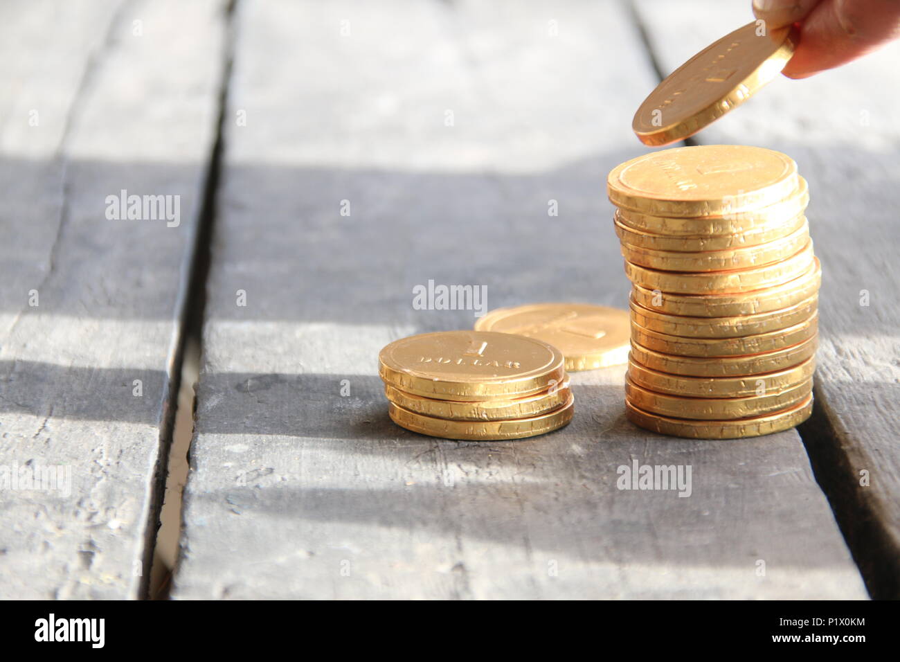 Woman stacking coins table hi-res stock photography and images - Alamy