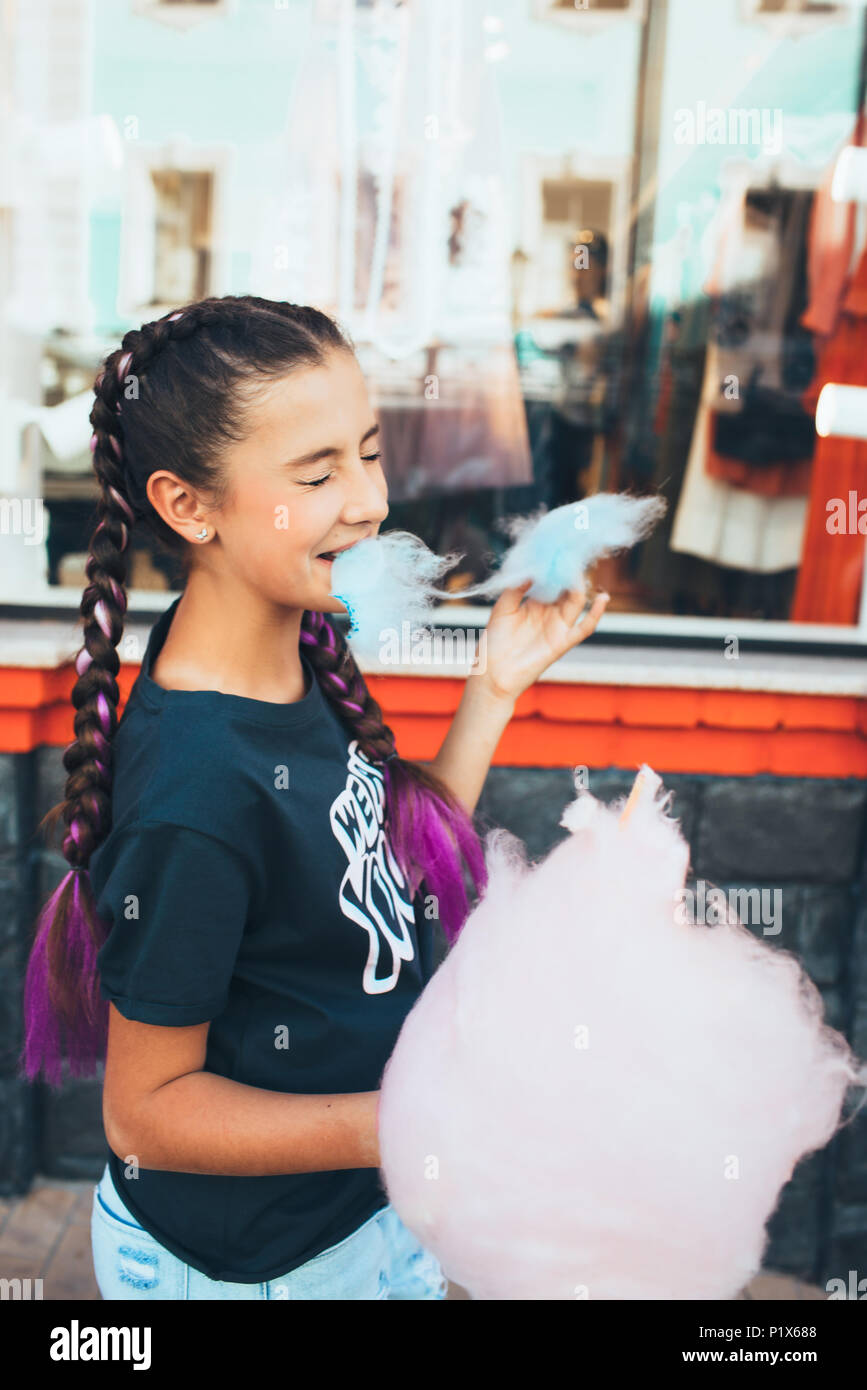 Girl funny eating cotton candy Stock Photo