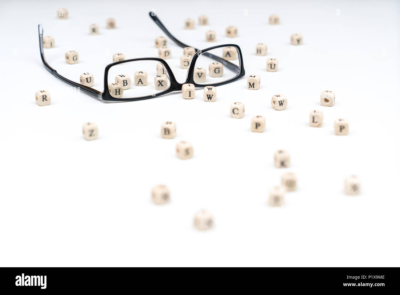 a pair of glasses between the letters of the alphabet Stock Photo