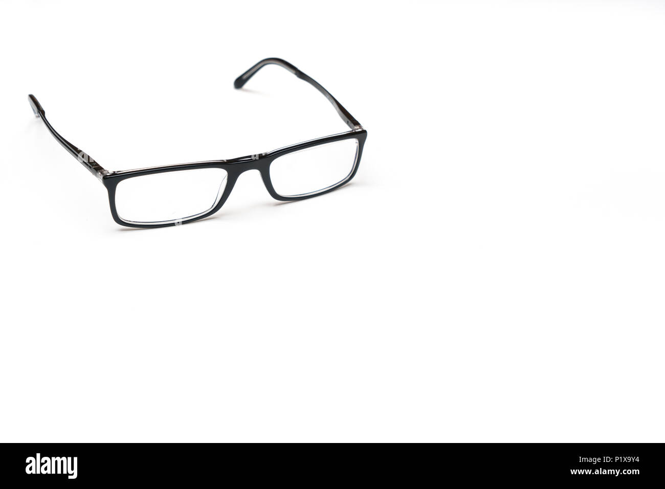 a pair of eyeglasses on a white surface Stock Photo