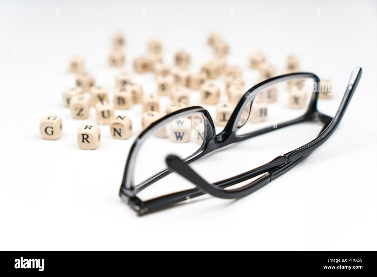 a pair of glasses between the letters of the alphabet Stock Photo
