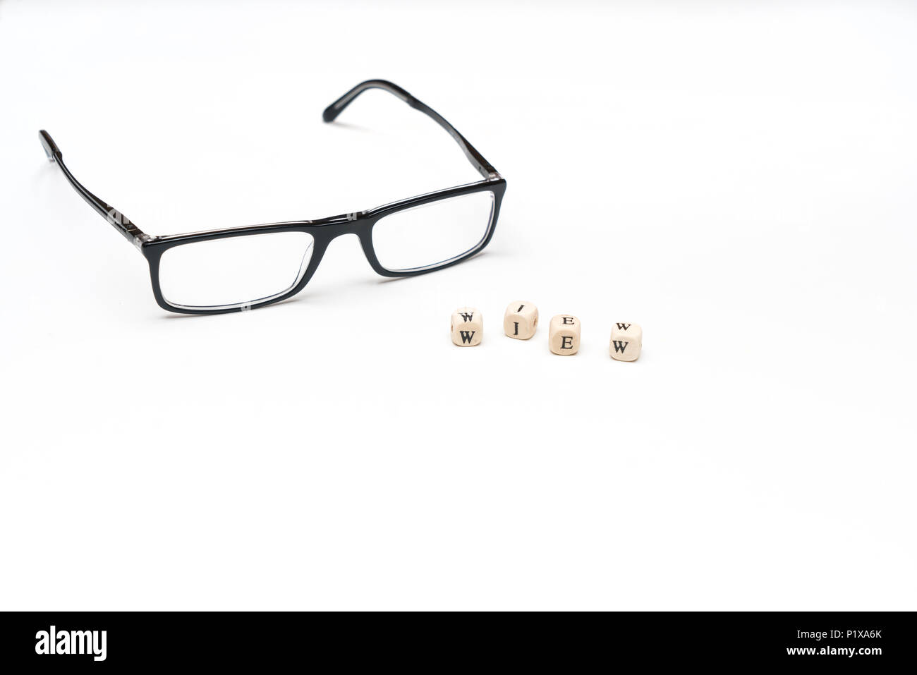 the word view and a pair of glasses on a white surface Stock Photo