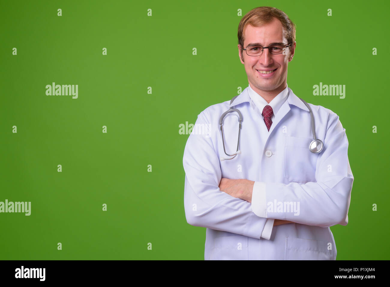 Young smiling doctor crossed hi-res stock photography and images - Alamy