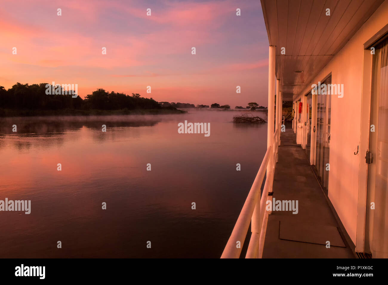 Pantanal region, Mato Grosso, Brazil, South America.  Colorful sunrise on the Cuiaba river, seen from the walkway on a flotel (floating hotel). Stock Photo