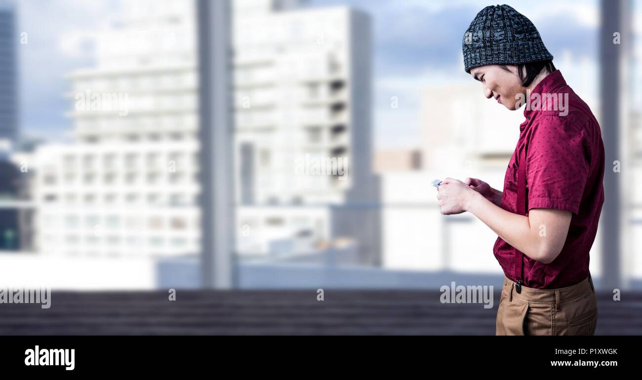 Man using phone with bright city background Stock Photo