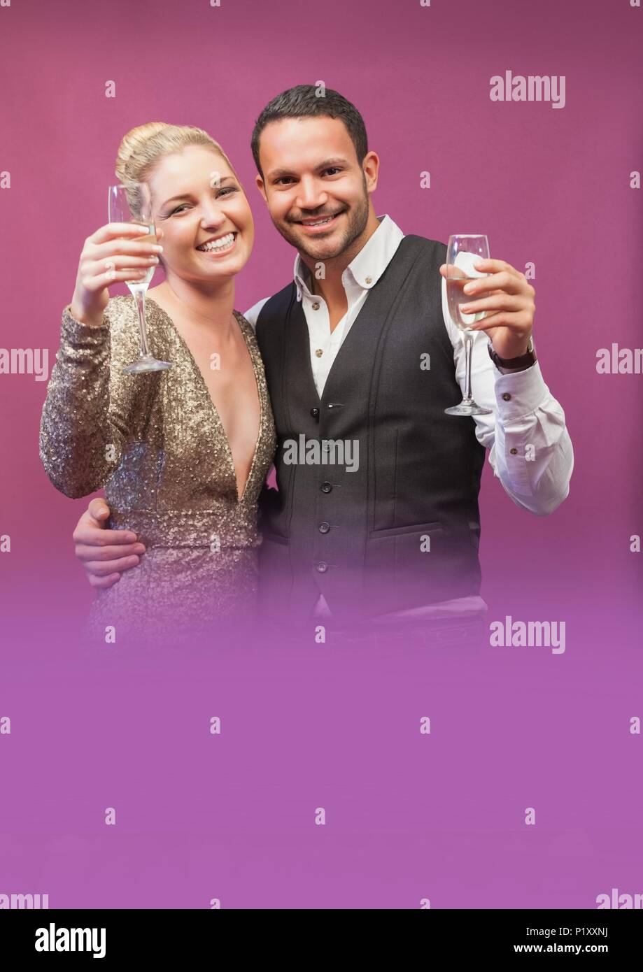 Glamorous couple holding champagne glasses Stock Photo