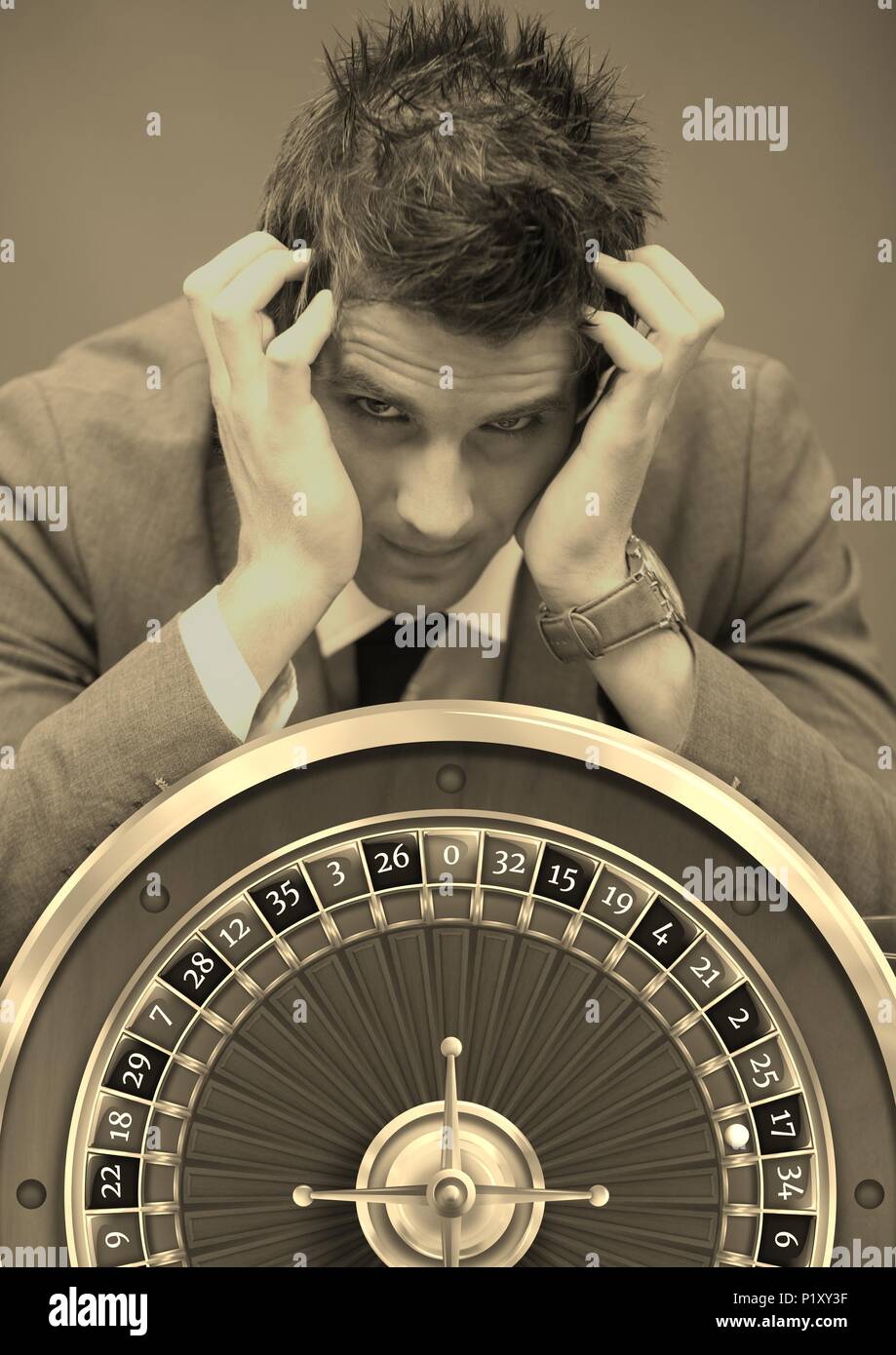 Stressed Gambling addict and casino roulette Stock Photo