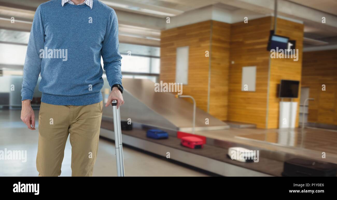 Man with luggage in airport at baggage collection Stock Photo