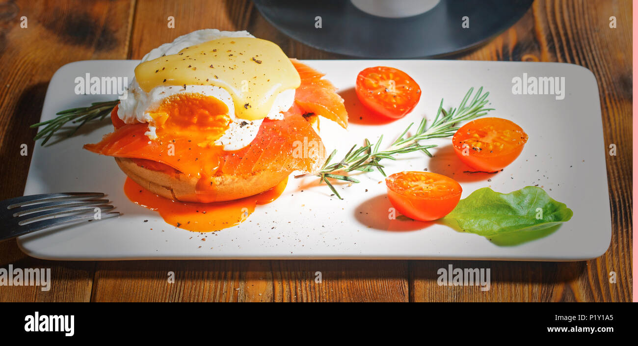 Egg Benedict with smoked salmon and fresh Hollandaise sauce Stock Photo