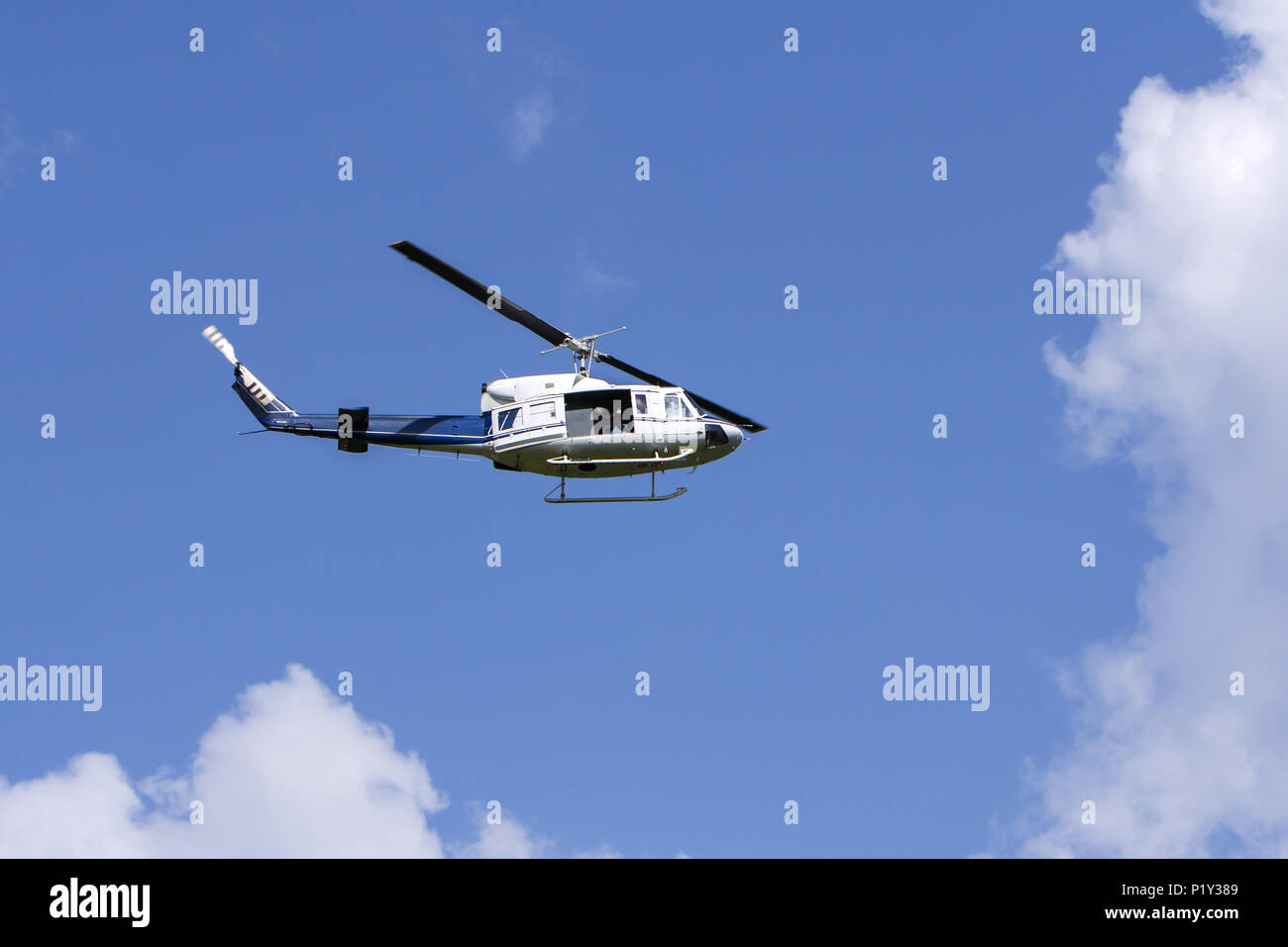 Blue helicopter flight in the sky Stock Photo