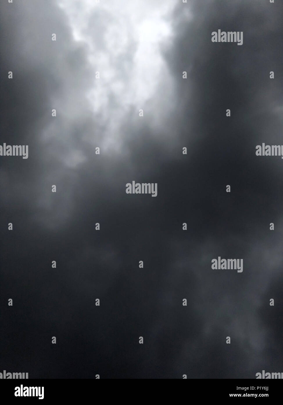 dark dense gloomy dramatic thundercloud on summer day Stock Photo