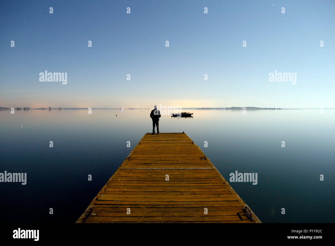 The Marne. Haute-Marne. Lake of DER in winter. Site of Chantecoq of night. Pontoon on the lake. Man admiring the lake. Stock Photo