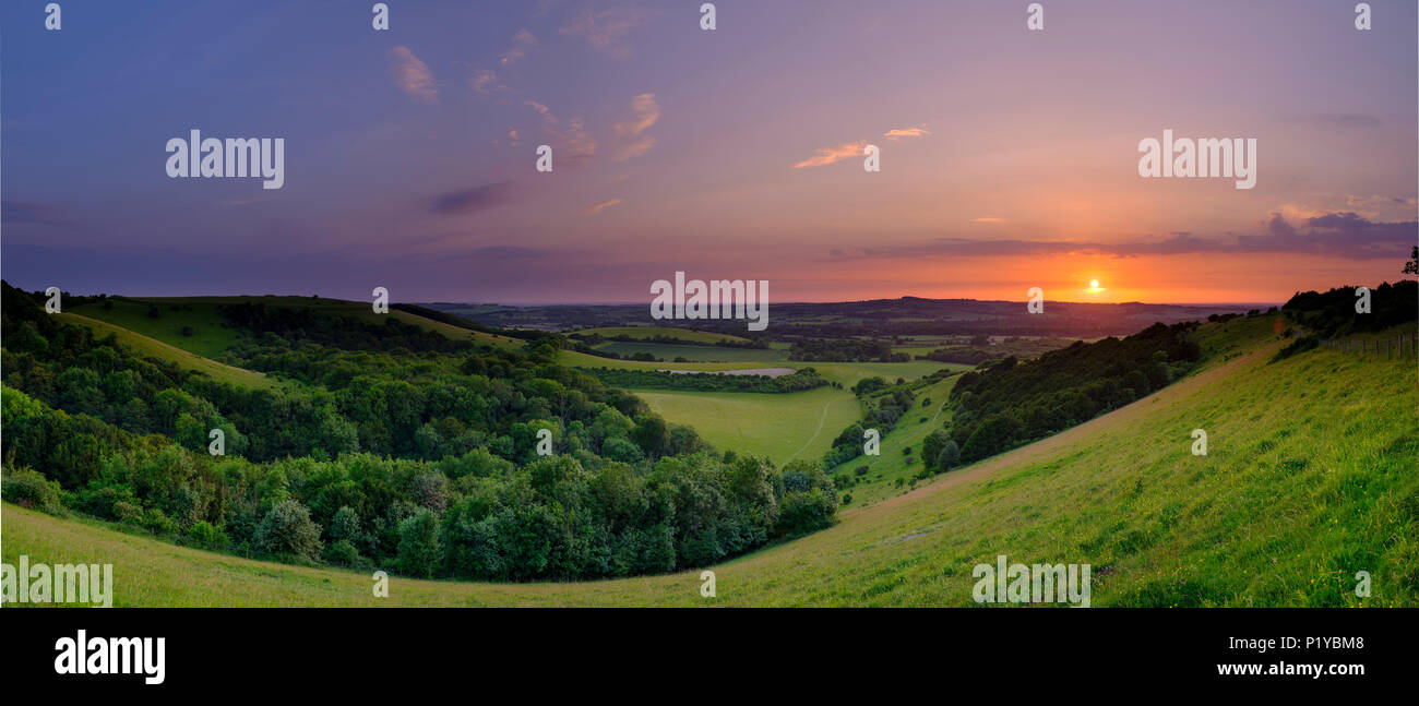 Dramatic and colourful mid-summer sunset over Beacon Hill from Old Winchester Hill in the South Downs National Park near Warnford, Hampshire, UK Stock Photo