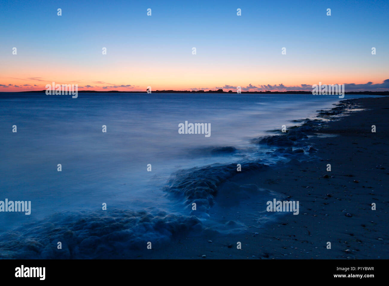 Normandy. Manche. Montmartin on Sea. Rising tide on the beach in the twilight. Stock Photo