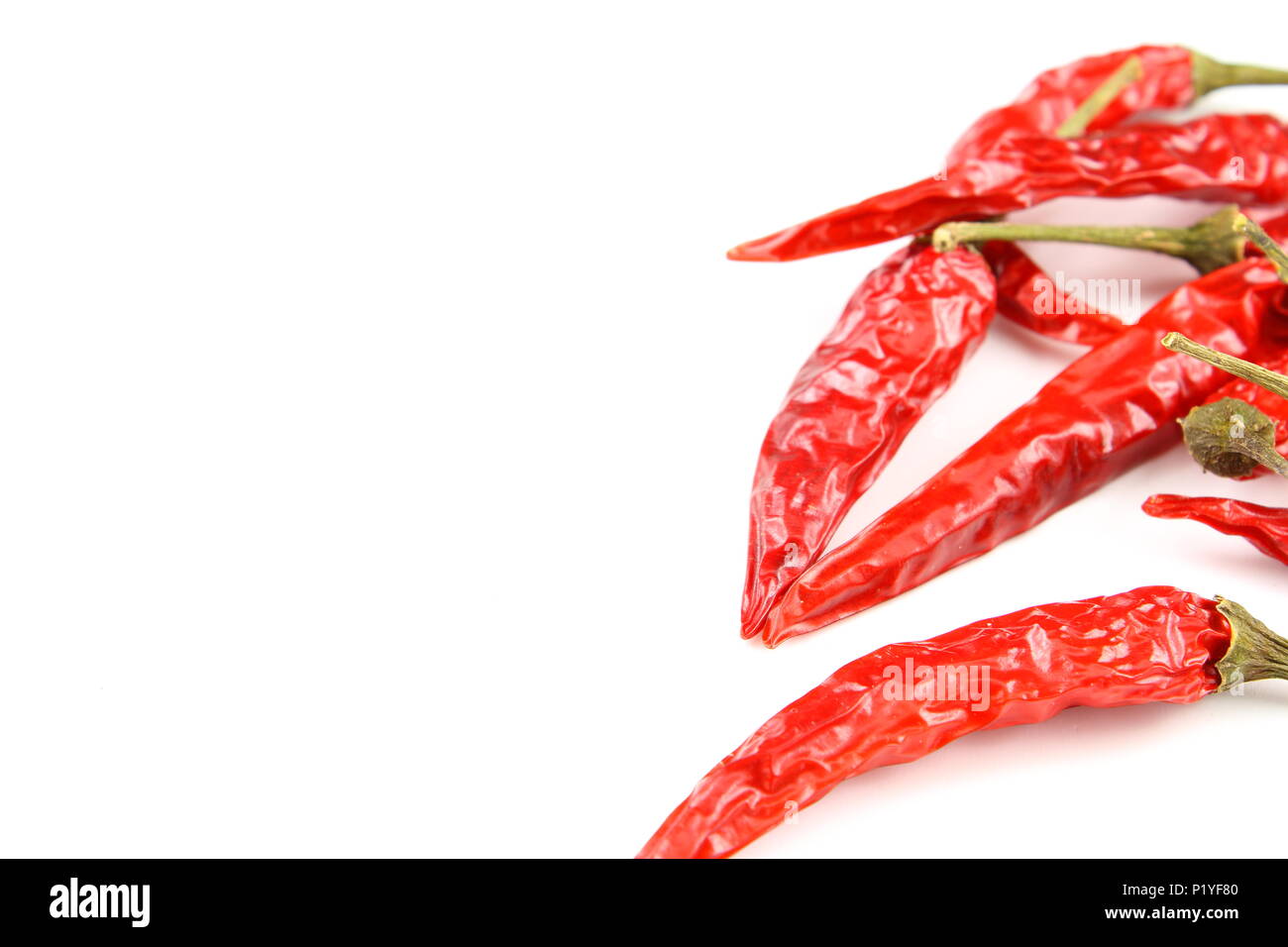 dried thai chili peppers isolated on a white background as a food background texture Stock Photo